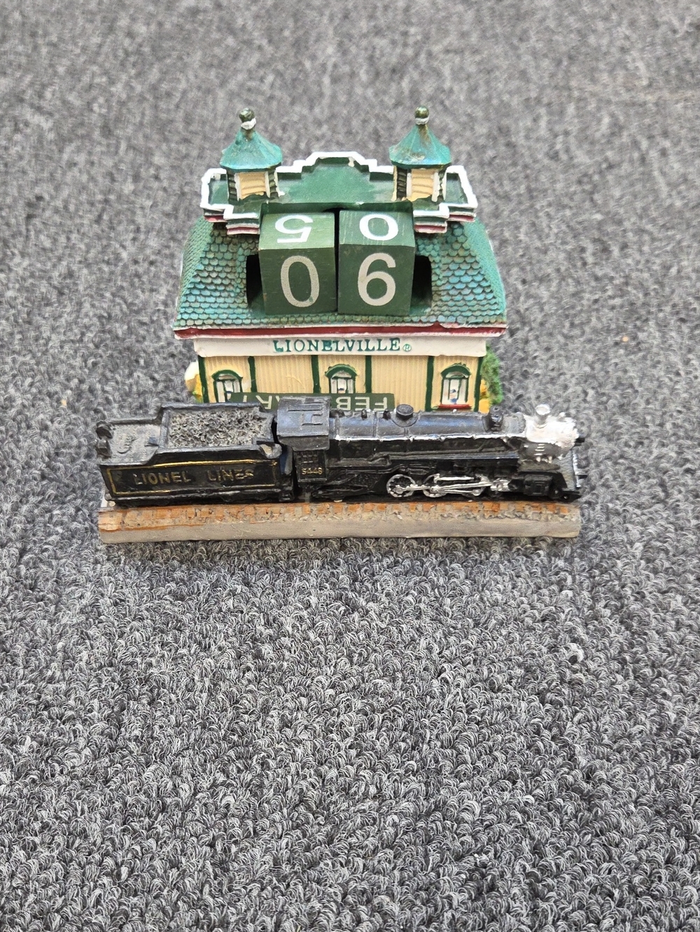 Lionelville Green Roof Perpetual Calendar with Black Train Figurine